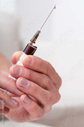 Photo: Hands with syringe Hands with syringe