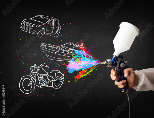 Photo: Man with airbrush spray paint with car, boat and motorcycle draw Man with airbrush spray paint with car, boat and motorcycle draw