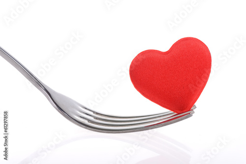 Photo: Red heart with fork on white background Red heart with fork on white background