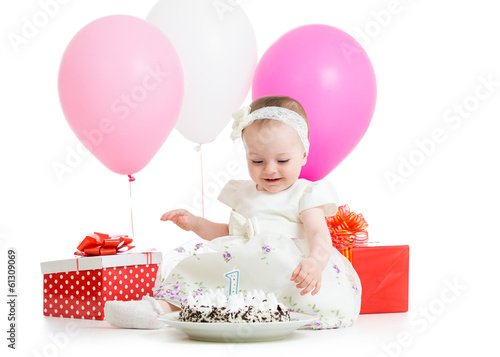 Photo: baby girl touching birthday cake baby girl touching birthday cake
