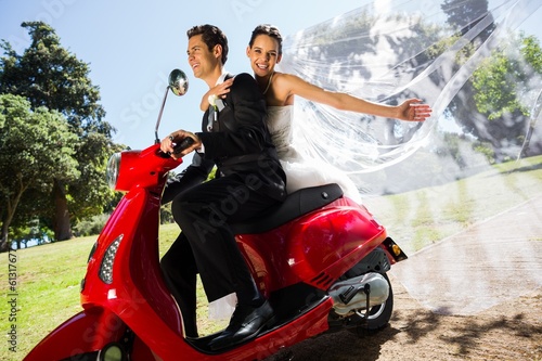 Photo: Newlywed couple enjoying scooter ride Newlywed couple enjoying scooter ride