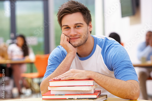 Photo: Male Student Studying In Classroom With Books Male Student Studying In Classroom With Books