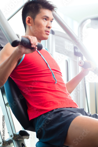 Photo: Chinese Man training strength in fitness gym Chinese Man training strength in fitness gym