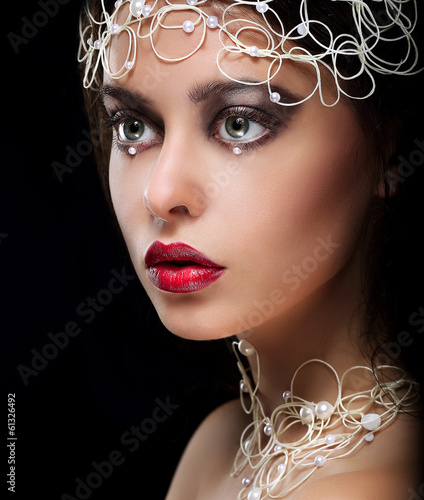 Photo: Decoration. Portrait of Gorgeous Woman with Pearls and Beads Decoration. Portrait of Gorgeous Woman with Pearls and Beads