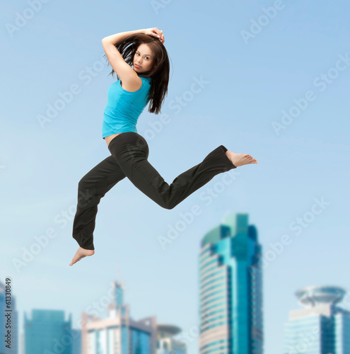 Photo: sporty woman jumping in sportswear sporty woman jumping in sportswear