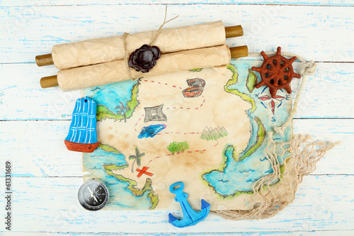 Photo: Treasure map with sea accessories, on wooden background Treasure map with sea accessories, on wooden background