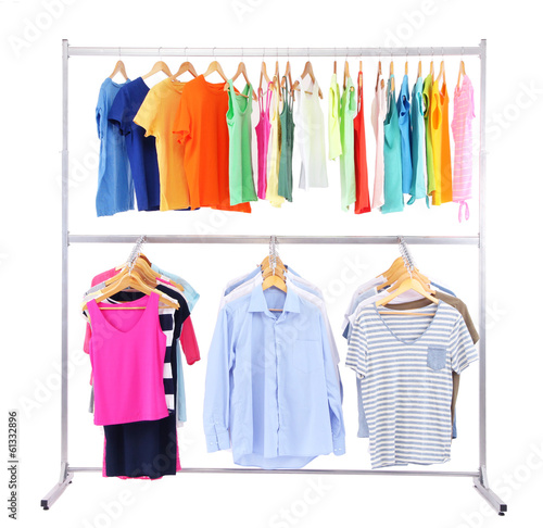 Photo: Different clothes on hangers, on gray background Different clothes on hangers, on gray background