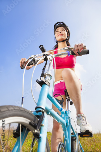 Photo: mountain woman biker and blue sky background mountain woman biker and blue sky background