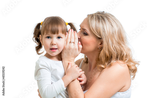 Photo: mother and kid sharing a secret whispering mother and kid sharing a secret whispering