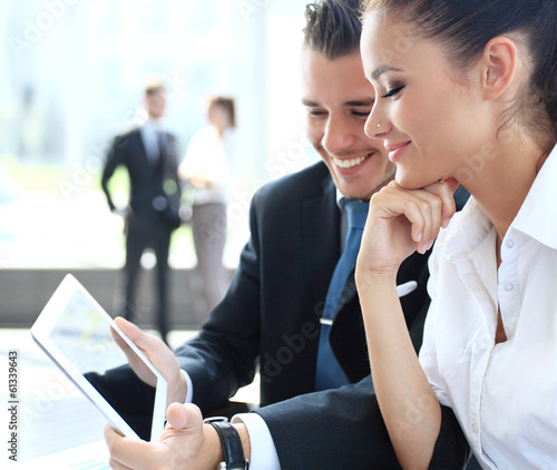 Photo: Business people meeting in office to discuss project Business people meeting in office to discuss project