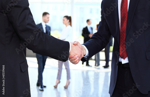 Photo: Closeup of business people shaking hands over a deal Closeup of business people shaking hands over a deal