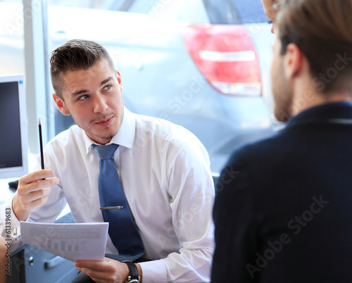 Photo: Happy business people talking on meeting at office Happy business people talking on meeting at office