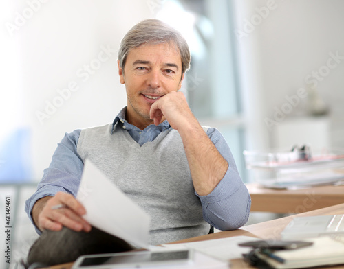 Photo: Portrait of senior businessman in office Portrait of senior businessman in office