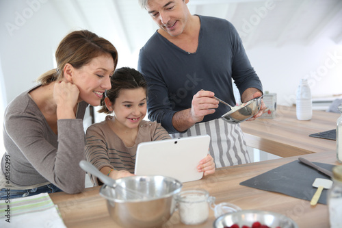 Photo: Family in home kitchen preparing pastry Family in home kitchen preparing pastry