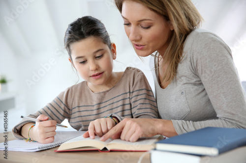Photo: Mom helping kid with homework Mom helping kid with homework