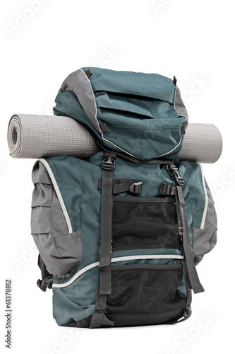 Photo: Studio shot of a backpack with exercising mat in it Studio shot of a backpack with exercising mat in it
