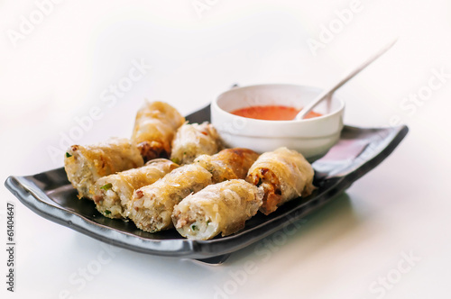 Photo: A plate of fried chinese spring rolls with chili sauce A plate of fried chinese spring rolls with chili sauce