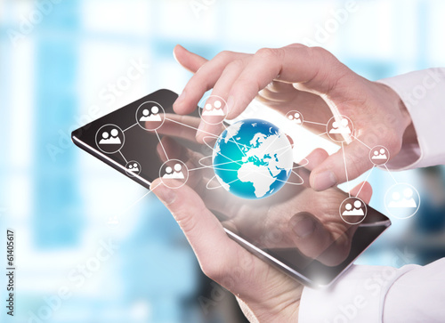Photo: Hand touching digital tablet Hand touching digital tablet
