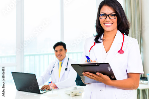 Photo: Asian doctor and nurse in surgery or office Asian doctor and nurse in surgery or office