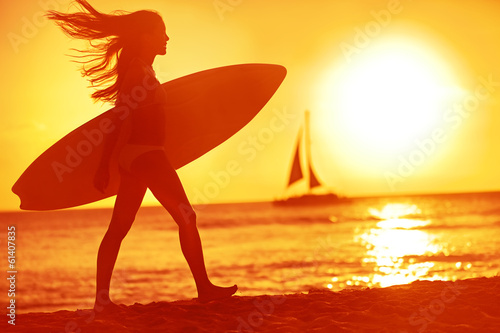 Photo: Surfing surfer woman babe beach fun at sunset Surfing surfer woman babe beach fun at sunset