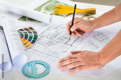 Photo: Draftsman Drawing Plan On Blueprint Draftsman Drawing Plan On Blueprint