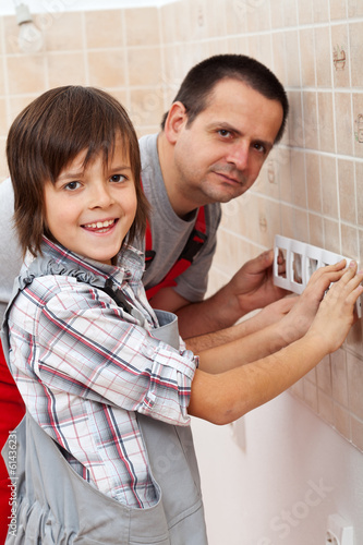 Photo: Working with dad - boy helping his father Working with dad - boy helping his father