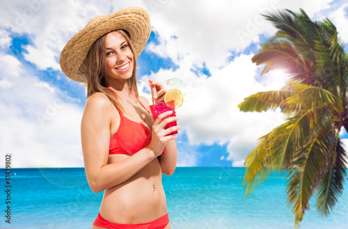 Photo: Woman drinking a cocktail on the beach Woman drinking a cocktail on the beach