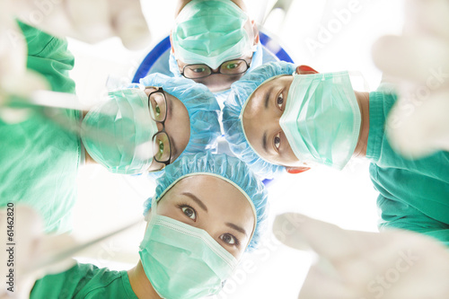Photo: Team surgeon at work in operating room. Team surgeon at work in operating room.