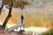 autumn landscape reflected in the water facing the young autumn landscape reflected in the water facing the young