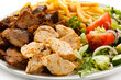 Grilled meat with French fries and vegetables Grilled meat with French fries and vegetables
