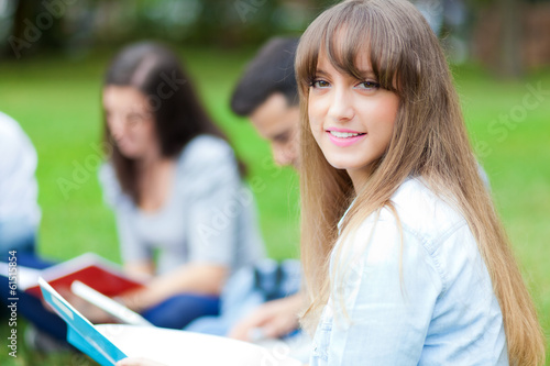 Photo: Students sitting at the park Students sitting at the park