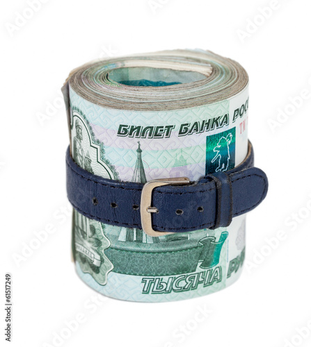 Photo: Russian rubles bills wrapped by belt isolated on white backgroun Russian rubles bills wrapped by belt isolated on white backgroun