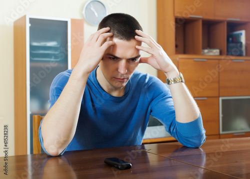 Photo: Man having disappointment after phone call Man having disappointment after phone call