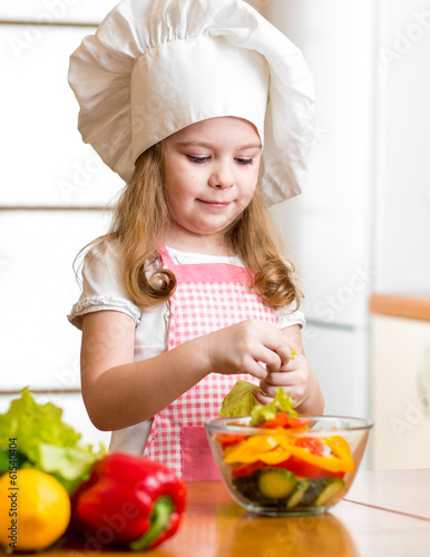 Photo: kid girl preparing healthy food vegetable salad kid girl preparing healthy food vegetable salad