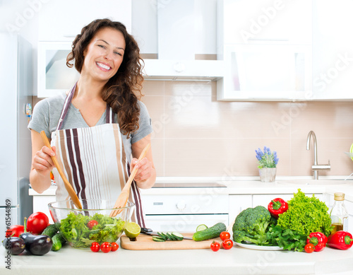 Photo: Young Woman Cooking. Healthy Food Young Woman Cooking. Healthy Food