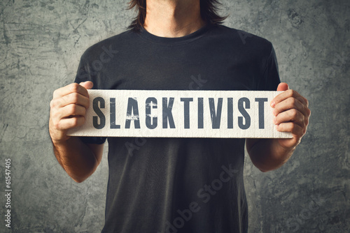 Photo: Man holding white banner with SLACTIVIST title Man holding white banner with SLACTIVIST title