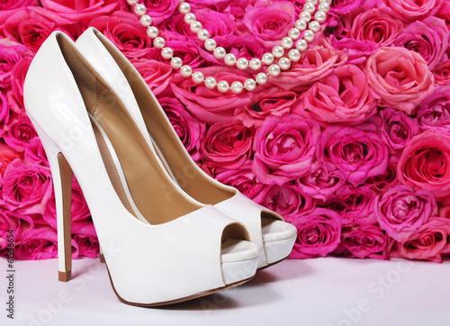 Photo: Bridal Shoes and Roses. White Heels over Hot Pink Flowers Bridal Shoes and Roses. White Heels over Hot Pink Flowers