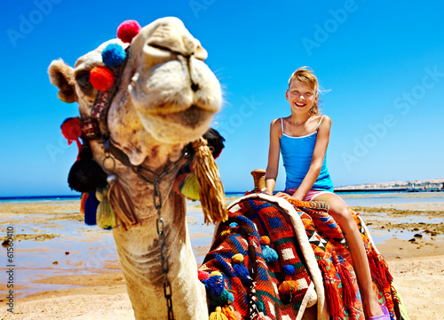 Photo: Tourists riding camel on the beach of Egypt. Tourists riding camel on the beach of Egypt.