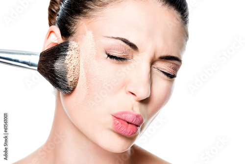 Photo: woman with powder on the skin of cheek woman with powder on the skin of cheek