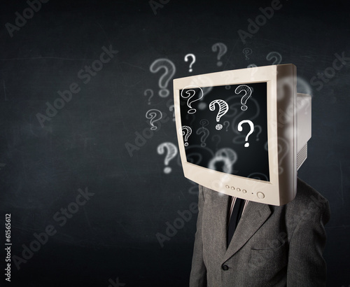 Photo: Businessman with a computer monitor head and question marks Businessman with a computer monitor head and question marks