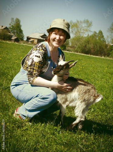 Photo: The Girl-farmer and young goat. The Girl-farmer and young goat.