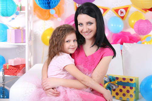 Photo: Pretty little girl with mom celebrate her birthday Pretty little girl with mom celebrate her birthday