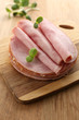 Tasty ham with sunflower sprouts on wooden background Tasty ham with sunflower sprouts on wooden background