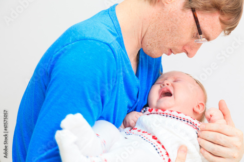 Photo: Newborn baby crying in father's hands Newborn baby crying in father's hands