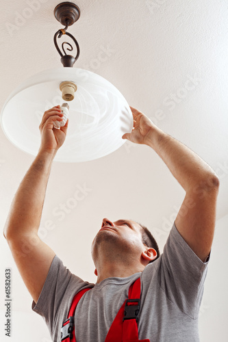 Photo: Electrician finished mounting ceiling lamp Electrician finished mounting ceiling lamp