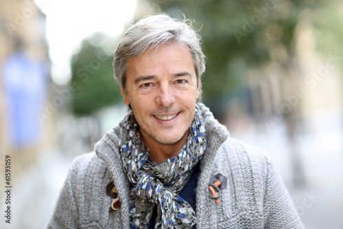 Photo: Portrait of attractive mature man in town Portrait of attractive mature man in town