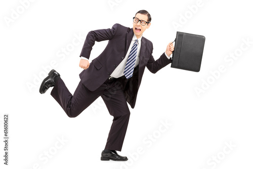 Photo: Scared male businessman running away from something Scared male businessman running away from something
