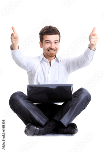 Photo: Business man celebrating his success with a computer laptop Business man celebrating his success with a computer laptop