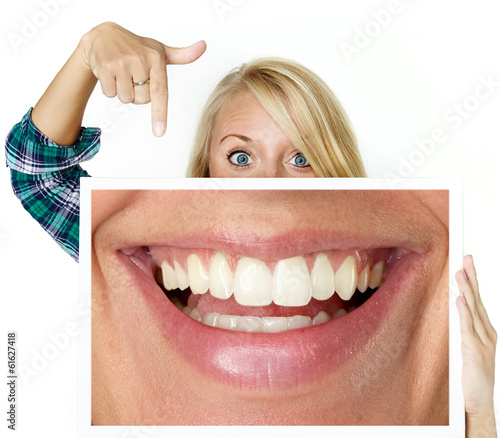 Photo: Woman shows picture with a big smile Woman shows picture with a big smile