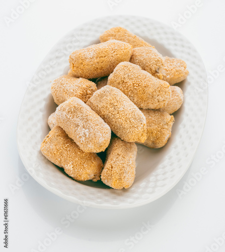 Photo: frozen croquettes, before cooking, in white tray frozen croquettes, before cooking, in white tray